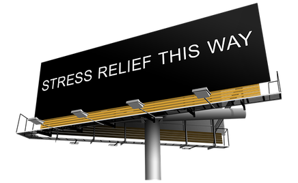 A picture of a giant billboard sign with the words stress relief this way.